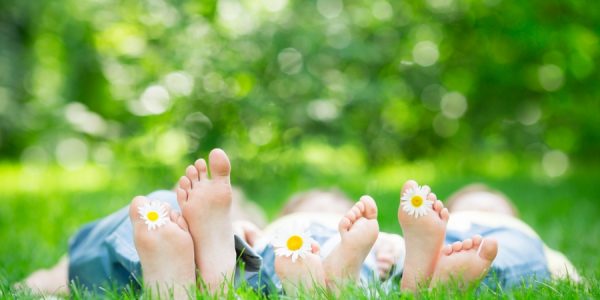 Family lying on grass outdoors in spring park